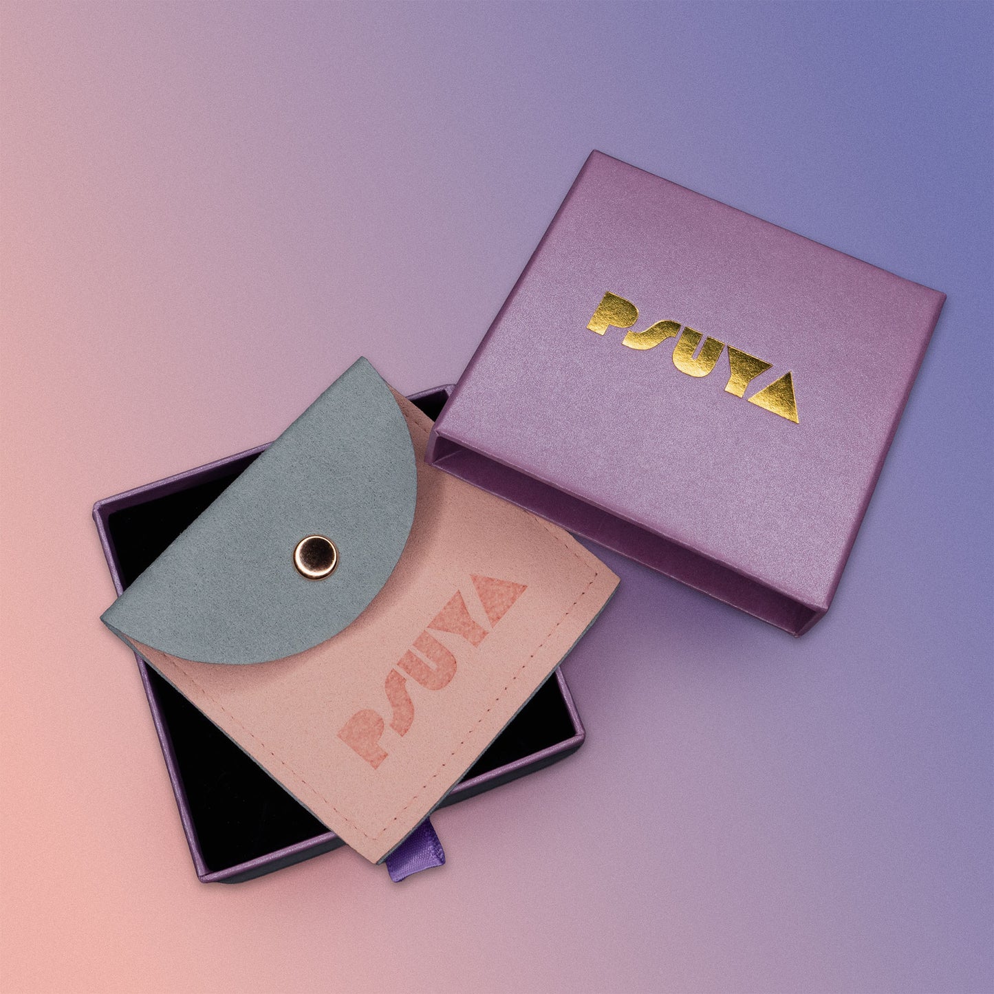 PSUYA product gift wrap packaging with a pink box and green pouch on a gradient background